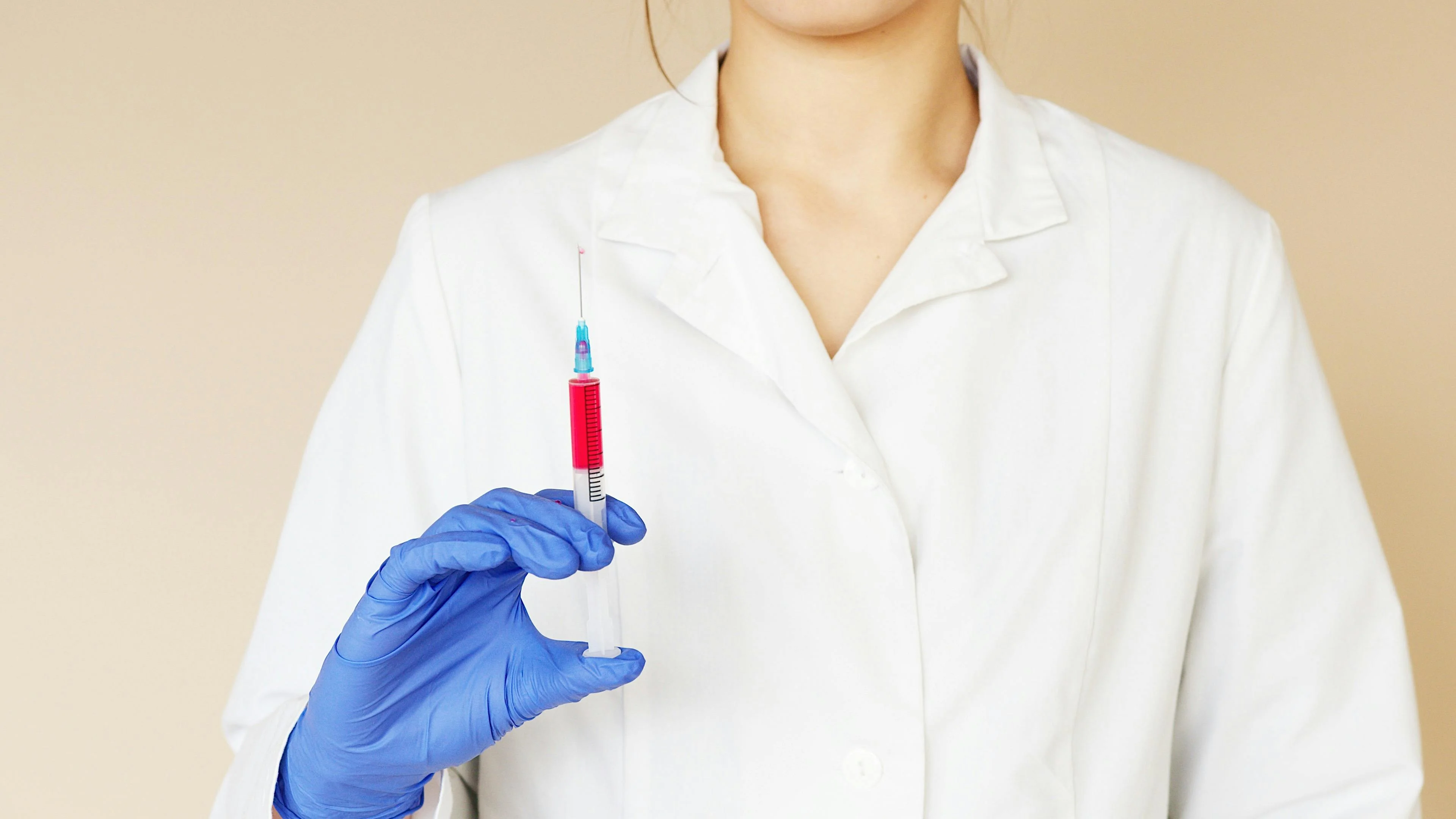 An image of a doctor holding up a syringe, highlighting Depo-Provera claims Clay Travis Law handles when injuries occur.