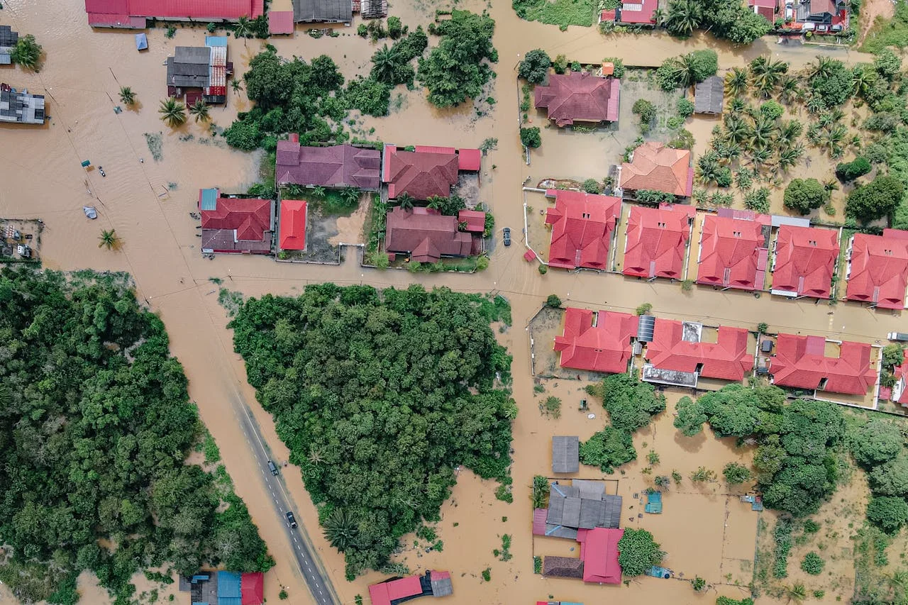 Over the top view of a severely flooded neighborhood after a heavy flood, representing the flood loss claims Clay Travis Law fights for.