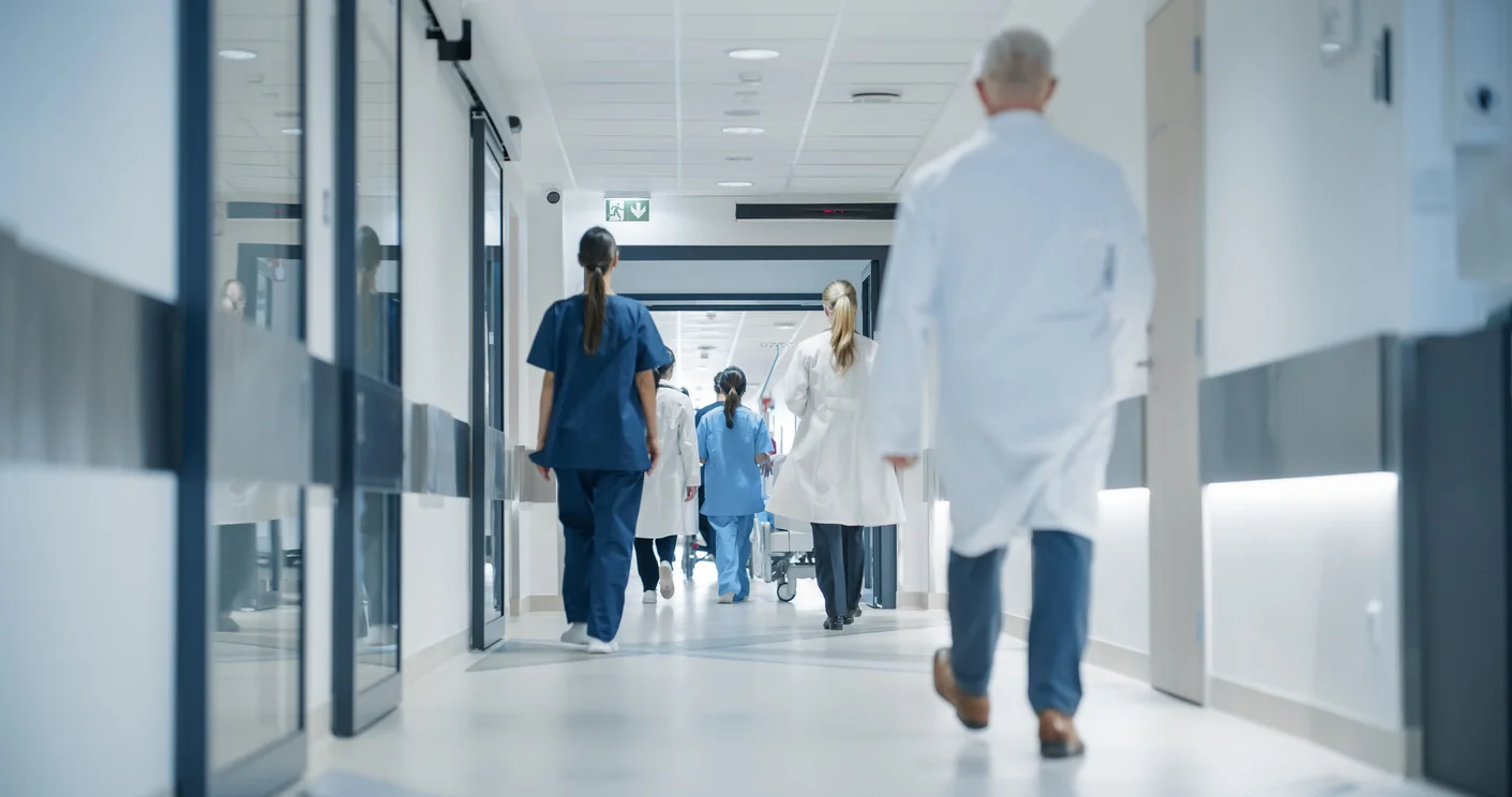 An interior shot of a hospital with nurses and doctors walking around, symbolizing medical malpractice cases Clay Travis Law fights to prove the truth.